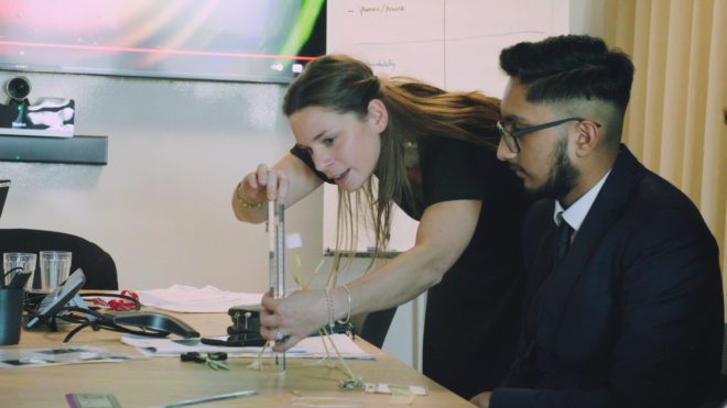 A Wates employee demonstrating an activity to one of the St. John's Bosco students.