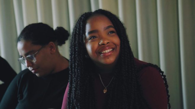 A school student smiling during an activity on the Wates Beacon programme.