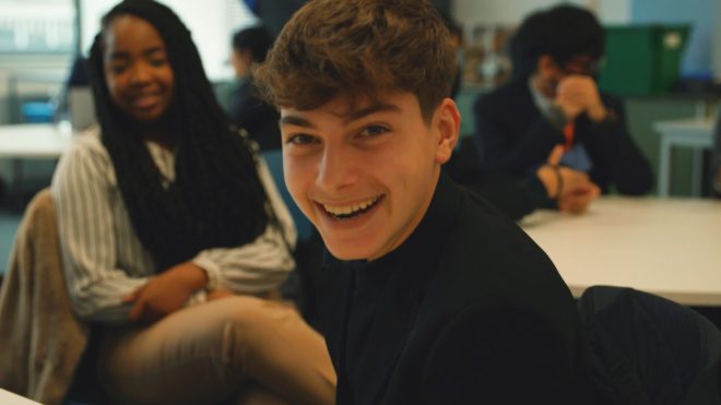 A school student smiling during an activity on the Wates Beacon programme.
