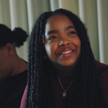young person at St John Bosco College smiles up